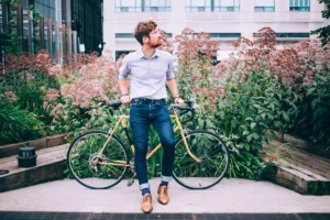 mens-fashion-man-in-shirt-and-jeans-leaning-on-bicycle