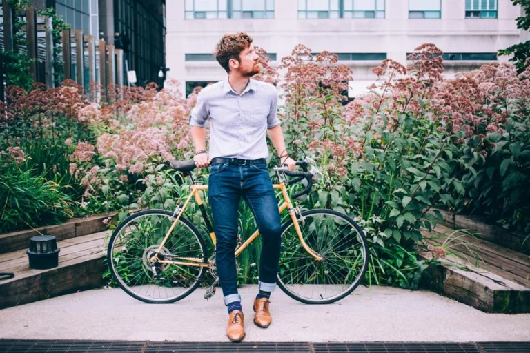 mens-fashion-man-in-shirt-and-jeans-leaning-on-bicycle
